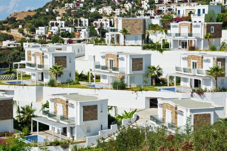 Contemporary villas in Bodrum, Turkey, amidst lush greenery and vibrant blooms.